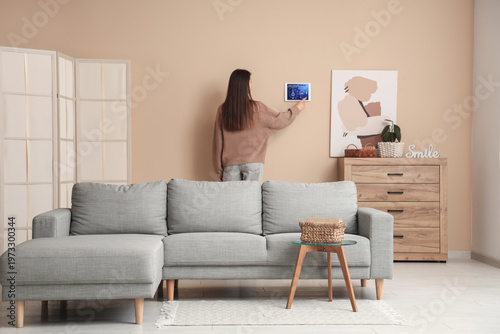 Woman using smart home secu...
