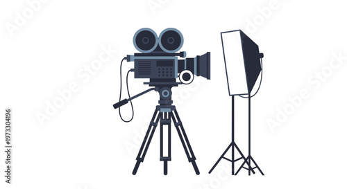 A professional black movie camera is securely mounted on a sturdy tripod next to a large white studio softbox light against a plain background.