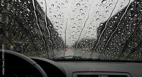 Rainy day car driving view through windshield with water droplets, blurred road, moody weather, safe driving concept, monsoon atmosphere