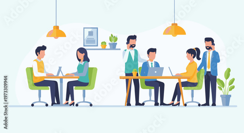 Colleagues collaborating and working on laptops in a modern office environment