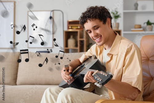 Young man playing guitar wh...