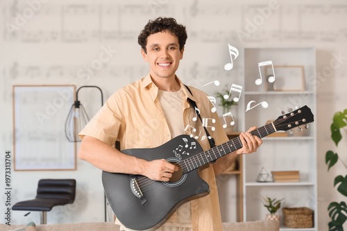 Happy young man playing gui...