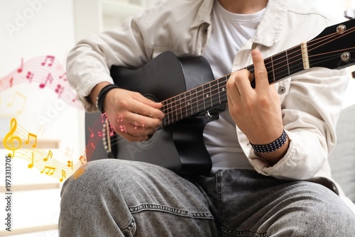 Young man playing acoustic ...