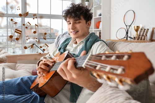 Happy young man playing gui...