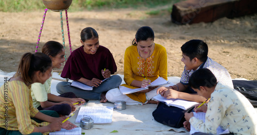 Bilde på lerret Indian villager girl boy sitting on mat do study read book outdoor rural area ground place