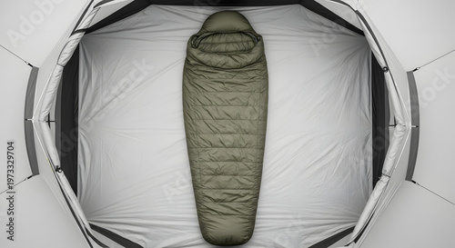 Overhead view of a green sleeping bag inside a white tent, ready for camping.