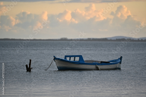 Small Fishing Boat on Calm Water at Sunset – Minimal Seascape Scene
