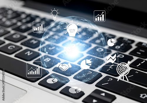 A close up view of a laptop keyboard with glowing digital business icons representing strategy growth and innovation concept