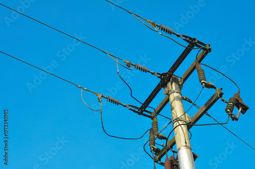 High Voltage Power Lines on Utility Pole Against Blue Sky