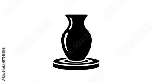 Black vase on a plate.