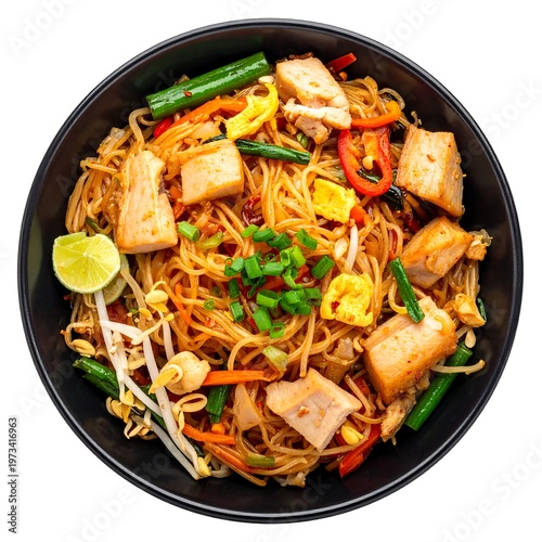 A vibrant, overhead shot showcases a black bowl brimming with flavorful noodles. It contains chicken, fresh vegetables, bean sprouts, and a lime wedge