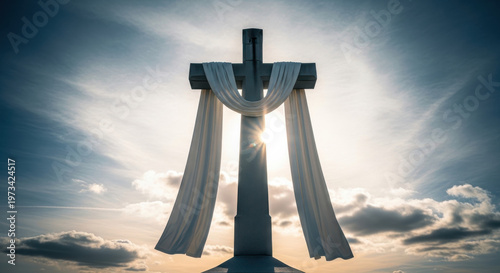 Dramatic christian cross with white cloth at sunset