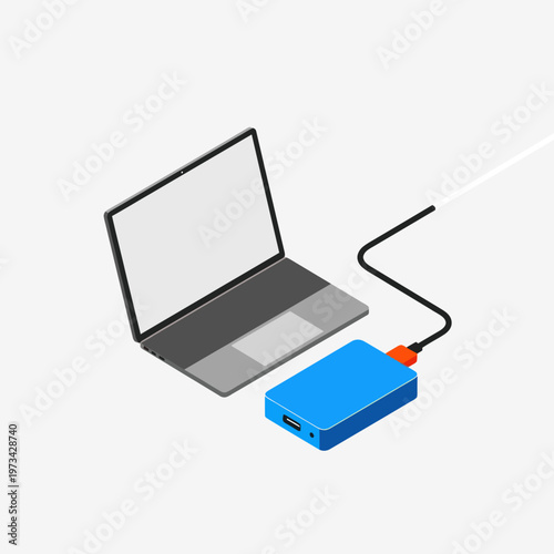 Laptop connected to external hard drive for data backup.