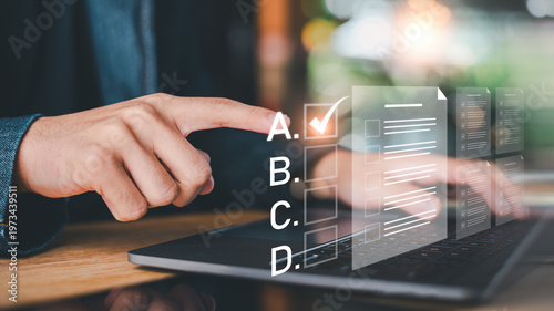 Photos Student selecting correct answer in digital exam interface, focusing on knowledg