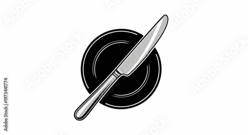 A silver knife rests diagonally across a black plate on a white background