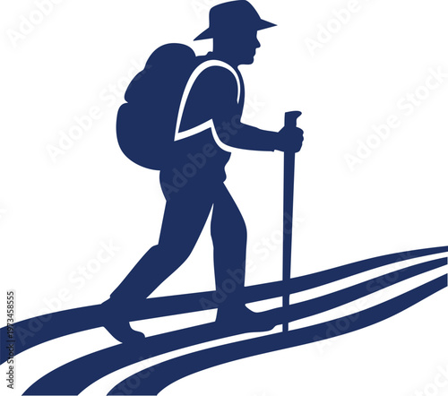 A silhouette of a hiker using trekking poles on a winding mountain trail pathway
