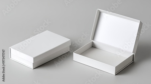 Two elegant white gift boxes on a gray surface in studio lighting