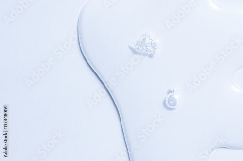 Cosmetic product in the form of a transparent drop. A moisturizing gel or serum for the face. Copy space
