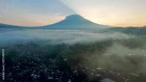 Golden Sunrise Behind Mount Sumbing with Floating Cloud Mist Over Village