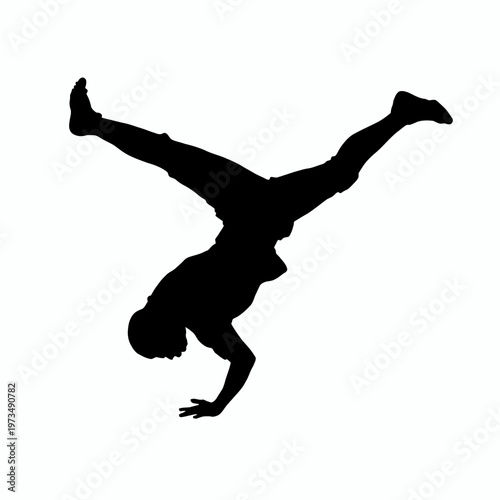 A person silhouetted, demonstrating a handstand while breakdancing