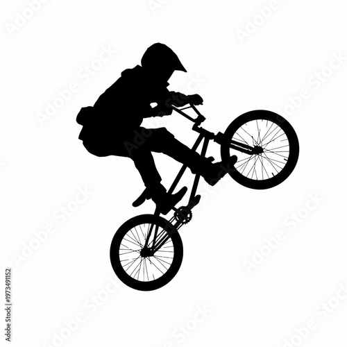 A silhouette of a BMX rider performing a wheelie trick on a bicycle