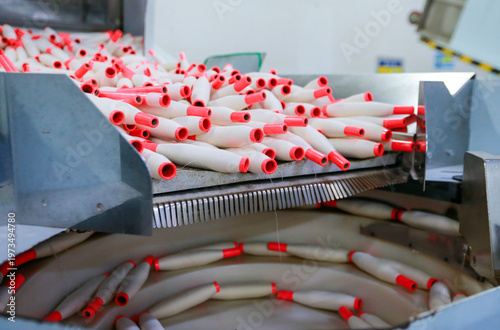 Many spinning spools are stacked together