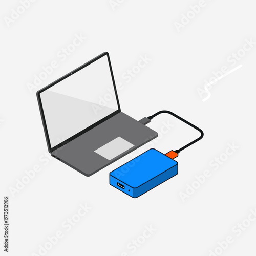Laptop connected to external hard drive for data backup.