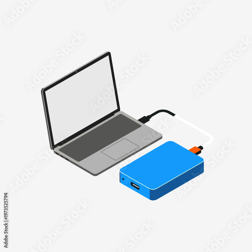 Laptop connected to external hard drive for data backup.