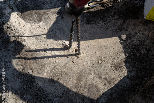Power hammer drill making holes in concrete
