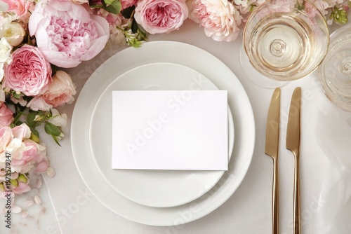 Elegant Wedding Table Setting with Floral Arrangement and Place Card.