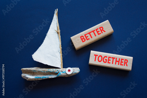 BETTER TOGETHER symbol. Concept word BETTER TOGETHER on wooden blocks. Beautiful deep blue background with boat. Business and BETTER TOGETHER concept. Copy space