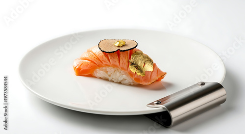 a modern 'fusion' sushi a delicate piece of seared salmon nigiri topped with a fine slice of truffle and gold leaf, on a sleek, white porcelain plate with a brushed metal accent 