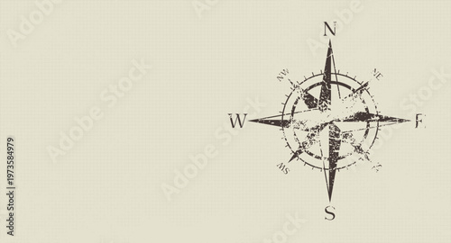 Vintage compass rose with grunge texture on neutral background representing navigation