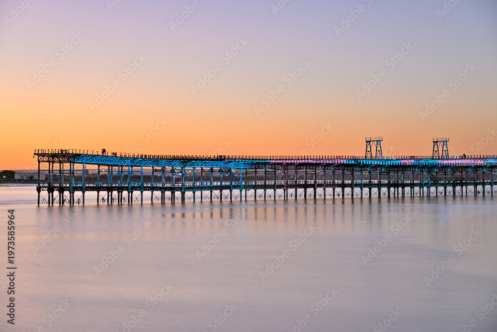 Fototapeta premium Mining pier of Huelva glowing in the golden dusk light