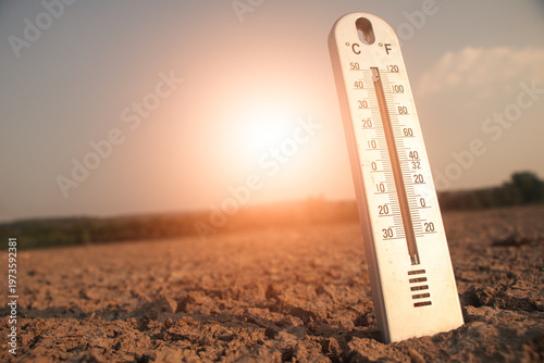 Thermometer showing high temperature under strong sunlight heat levels and climate crisis.