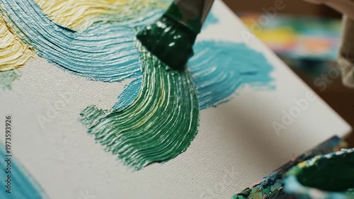 Hand painting green impasto texture onto white canvas