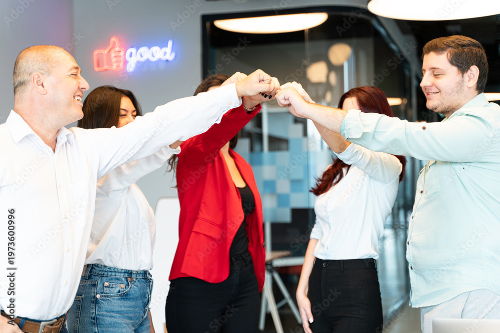 Obraz premium Business team unites with stacked hands in a modern office
