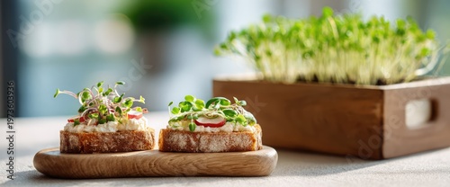 Two delicious open-faced sandwiches topped with fresh microgreens and served on a wooden board.