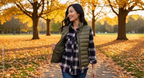 Smiling Woman in Autumn Park with Golden Leaves and Green Vest