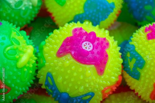 Neon spiky sensory rubber balls closeup, fidget toys in green and red