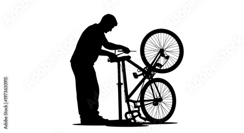 Man fixing bicycle in workshop.