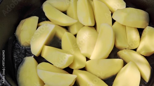 Golden Crispy Potato Pieces, Sizzling Peeled Potatoes In Hot Oil, Steaming And Bubbling Potato Wedges Frying In Warm Cast Iron Pan With Savory Aroma