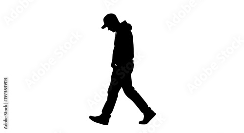 Silhouette of a man walking with a cap and hoodie.