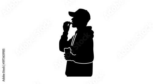 Silhouette of a person eating and holding a drink.