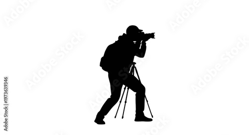 Silhouette of a photographer with camera and tripod capturing a moment.