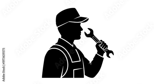 Silhouette of a skilled mechanic holding a wrench ready for repair work.