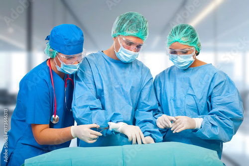 Three surgeons in blue gowns focus intently on a patient