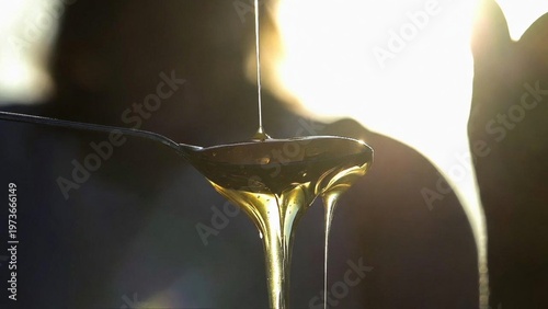 Golden liquid pouring slowly.