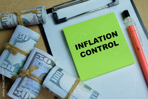 Concept of inflation control write on sticky notes isolated on Wooden Table. For financial planning, monetary policy and economic stability