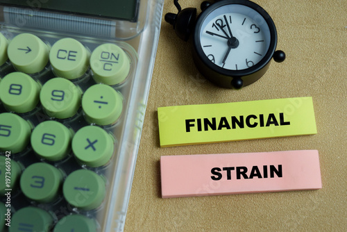 фотографія Concept of financial strain write on sticky notes isolated on Wooden Table